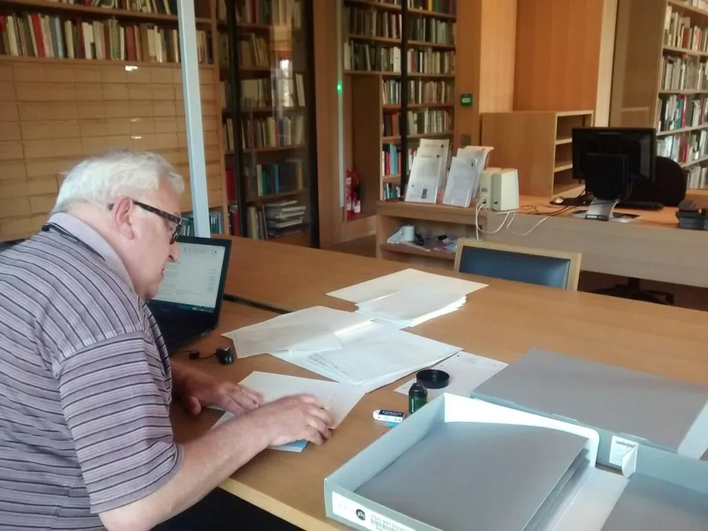 One of our project volunteers repacking correspondence into acid-free papers and folders
